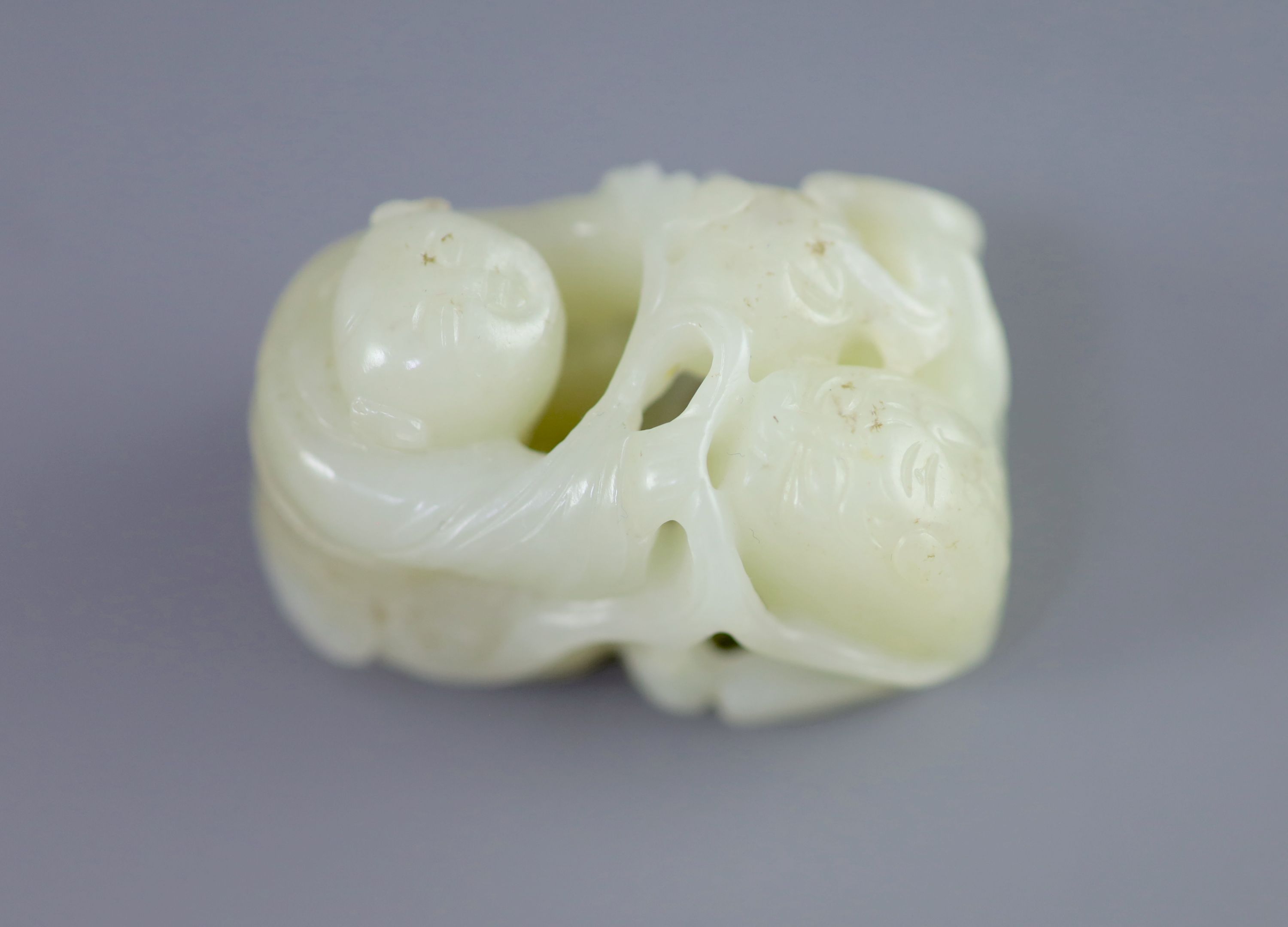 A Chinese pale celadon jade group of a boy and a lion-dog, 19th/20th century, 5.4cm